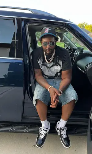 Peezy wearing Givenchy t-shirt