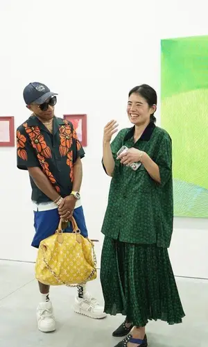 Pharrell Williams’ Outfit in Prada Shirt, Louis Vuitton Eyewear & Human Made Cap (2023)
