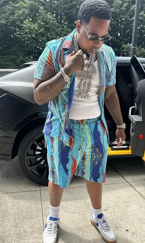 Finesse2tymes wearing Coogi shirt