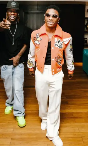 Wizkid wearing Louis Vuitton jacket