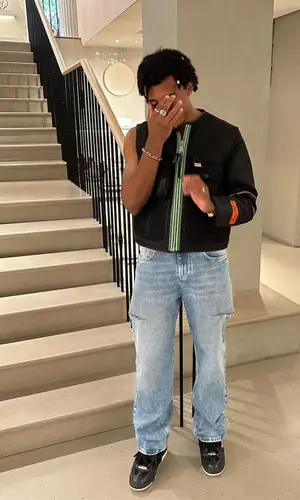 Jules Kounde’s Outfit in Heron Preston Jacket, Maison Margiela Jeans & Louis Vuitton Sneakers (2023)