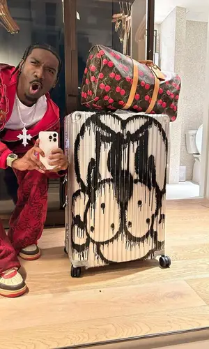Bruce Ray wearing Louis Vuitton bag