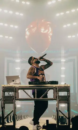 DJ Luian wearing Mitchell & Ness jersey