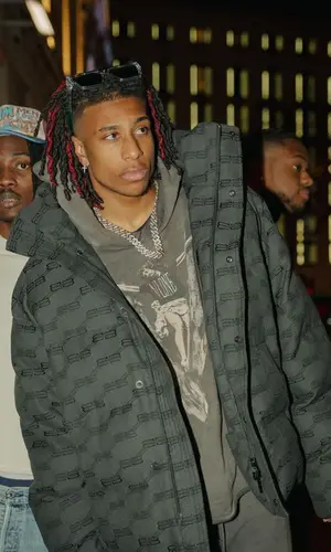 Michael Olise wearing Balenciaga jacket
