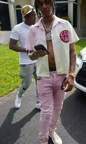 Skilla Baby wearing Amiri jeans