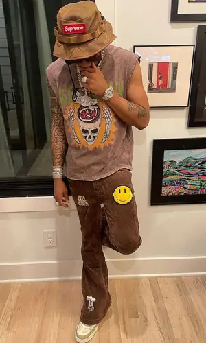 Lil Migo wearing Don't Let Mom Find Out t-shirt