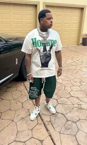 Finesse2tymes wearing Homme + Femme t-shirt