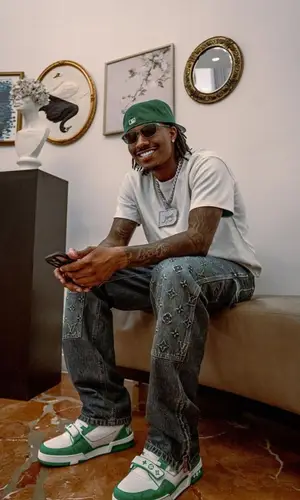 Duke Dennis wearing Louis Vuitton jeans