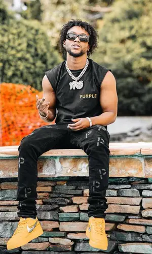 YourRAGE wearing Purple Brand top