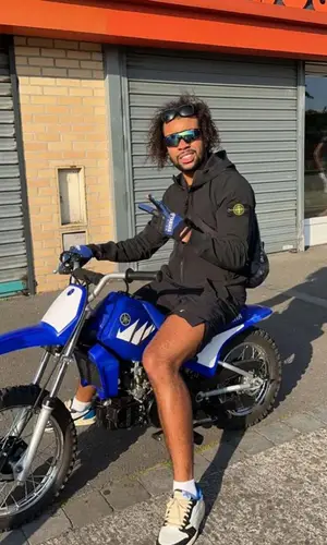 Gambi wearing Nike sneakers