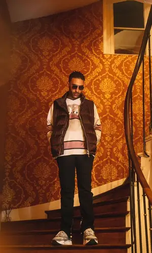 Heuss L'enfoire wearing Amiri jeans