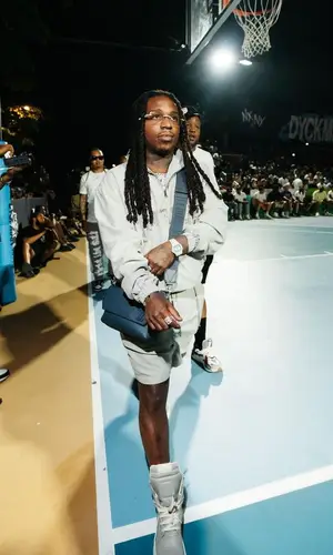 Jacquees wearing Louis Vuitton bag