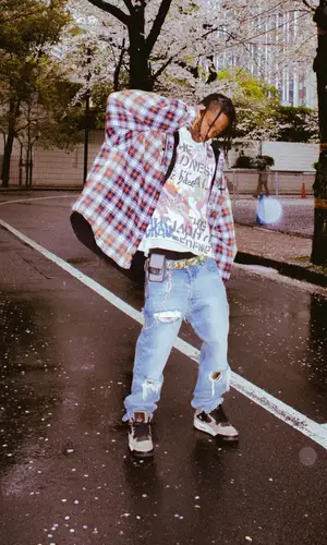 Travis Scott wearing Takashi Murakami belt