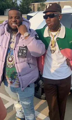 Maxo Kream wearing Warren Lotas t-shirt