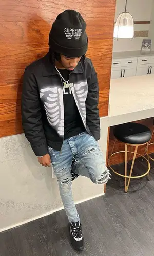 Lil Darius wearing Supreme hat