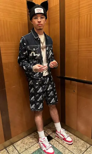 Lil Mosey’s Outfit in Evisu Jacket, Louis Vuitton Sneakers & Loverboy by Charles Jeffrey Hat (2023)