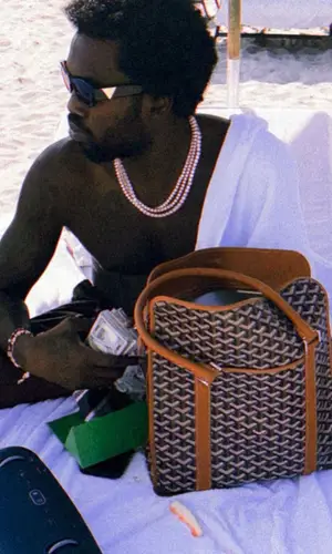 Meek Mill wearing Goyard bag