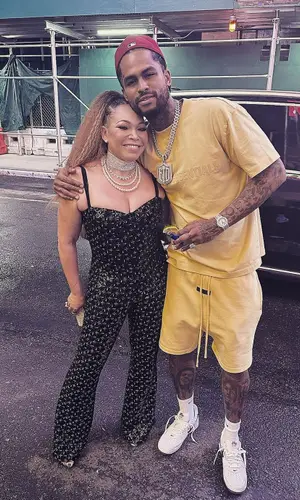 Dave East wearing Fear of God t-shirt