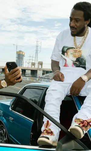 Mozzy wearing Amiri jeans