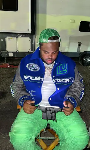 Tee Grizzley wearing Louis Vuitton jacket