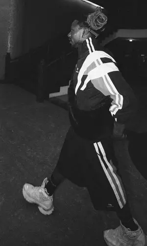 Asake wearing Balenciaga shorts