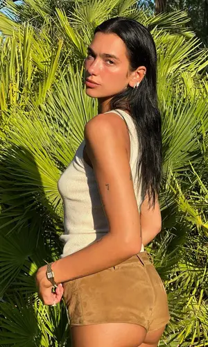 Dua Lipa’s Outfit in Miu Miu Top & Cartier Watch (2023)