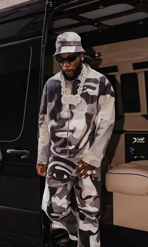 Burna Boy wearing Louis Vuitton jacket