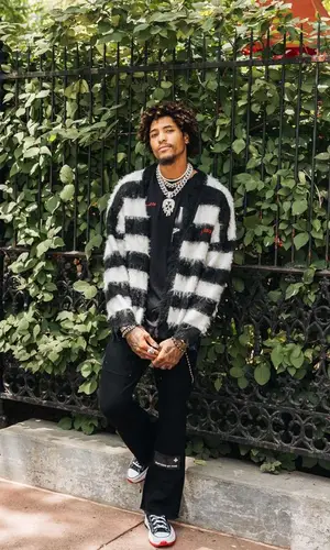 Kelly Oubre Jr wearing Godspeed sweater
