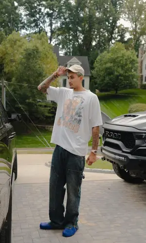 Kyle Kuzma’s Outfit in Vintage T-Shirt, Louis Vuitton Jeans & Dior Cap (2023)