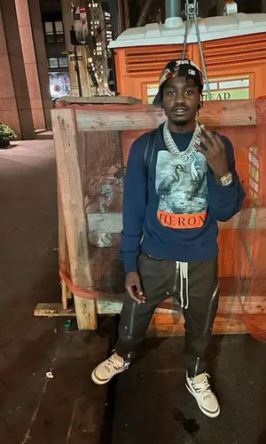 Lil Tjay wearing Heron Preston sweatshirt