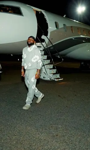 Davido wearing Denim Tears pants