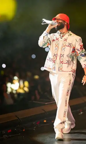 Arcangel wearing Bode pants