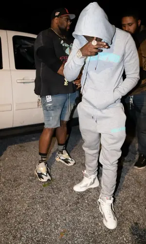 Bobby Shmurda’s Outfit in Fullypaid Hoodie & Prada Sneakers (2023)