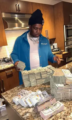 Big 30 wearing Palm Angels jacket