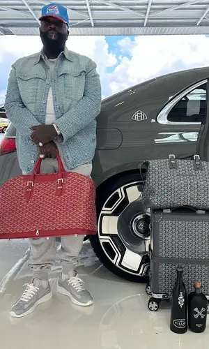 Rick Ross wearing Balmain jacket