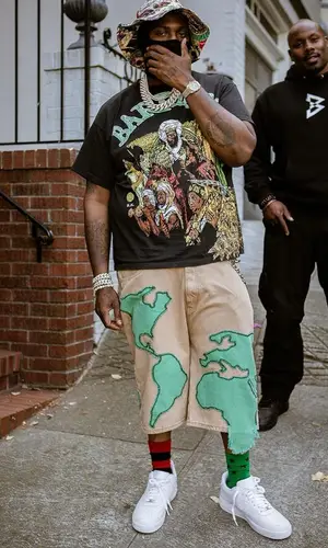 Peezy wearing Denim Tears sock