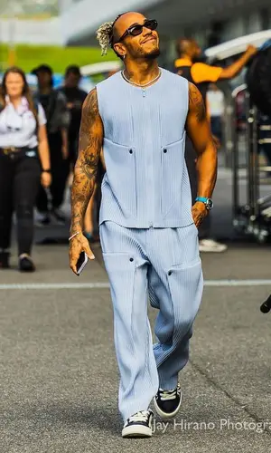 Lewis Hamilton’s Outfit in Issey Miyake Jacket, Dior Sneakers & Nanushka Eyewear (2023)