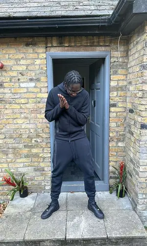 J1mulla wearing Nike pants