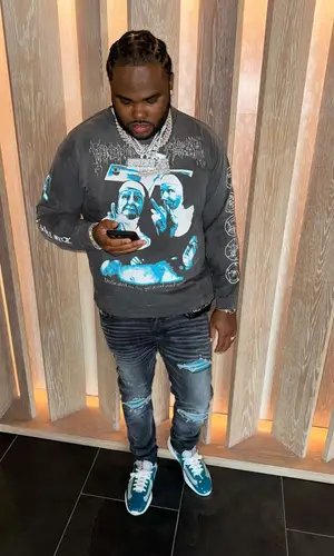 Tee Grizzley wearing Amiri jeans