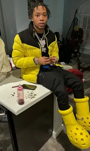 Lil Migo wearing Crocs boots