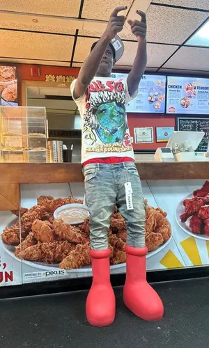 PGF Nuk’s Outfit in Hellstar T-Shirt, Purple Brand Jeans & MSCHF Boots (2023)