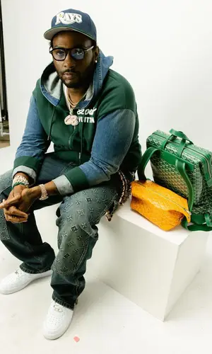 Peezy wearing Louis Vuitton pants