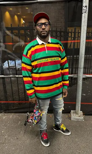 Peezy wearing Denim Tears shirt