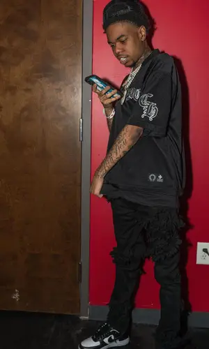 Lil Poppa wearing Chrome Hearts jersey