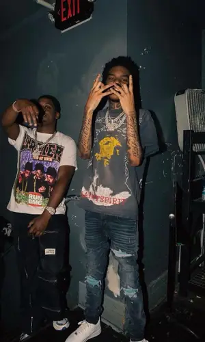 Lil Poppa wearing Saint Michael t-shirt