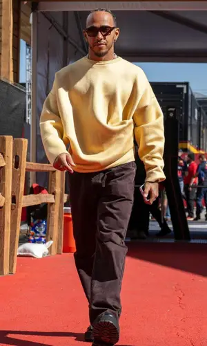 Lewis Hamilton’s Outfit in Loewe Sweater, Namacheko Jeans & Ahlem Eyewear (2023)