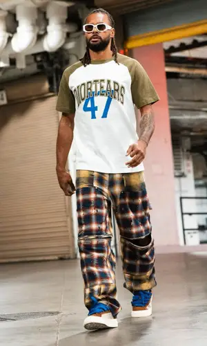 Patty Mills’ Outfit in Dior T-Shirt, Givenchy Pants & Denim Tears (2023)
