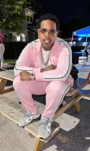 Finesse2tymes wearing Palm Angels pants