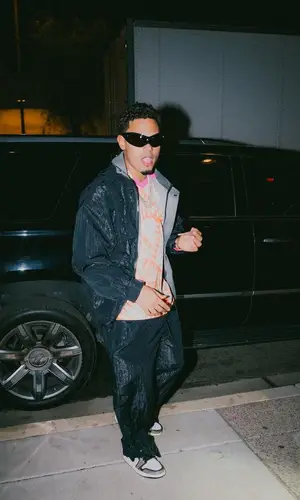 Myke Towers wearing Acne Studios jersey