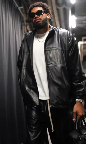Karl Anthony Towns’ Outfit in Balenciaga Jacket, Hermes Bag & Louis Vuitton Eyewear (2023)